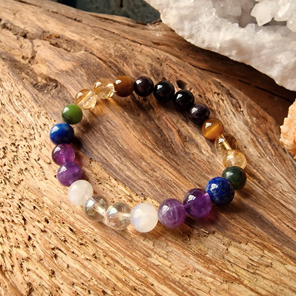 High-vibrational crystal bracelet designed to keep your energy centres in balance and made with Moonstone, Aura Quartz, Amethyst, Lapis Lazuli, Jade, Citrine, Tiger's eye, Garnet, and Obsidian. 