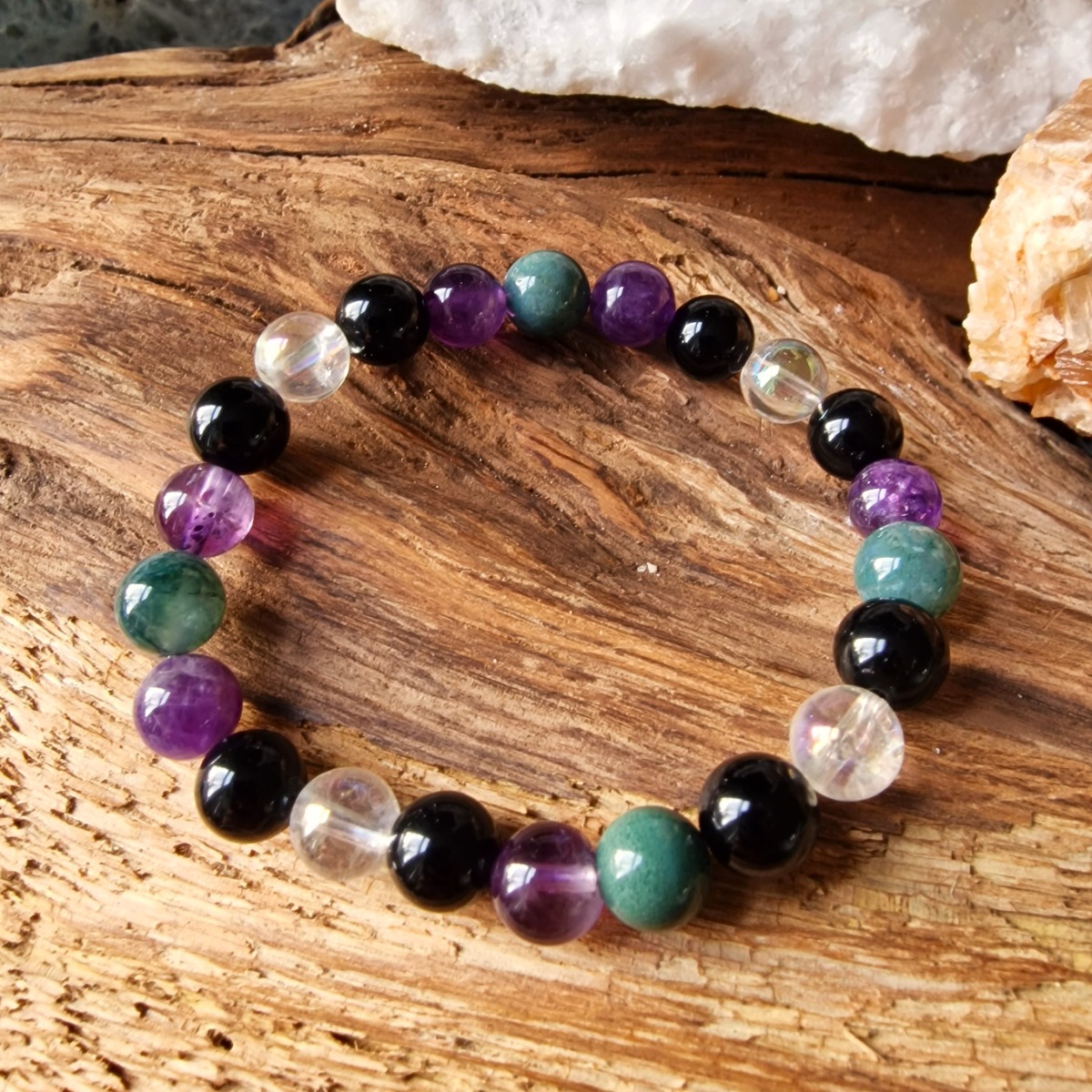 Insomnia healing crystal bracelet specifically designed for restful sleep, mental clarity, and personal growth. Made with natural high-vibrational crystals of Aura Quartz, Moss Agate, Amethyst and Obsidian.