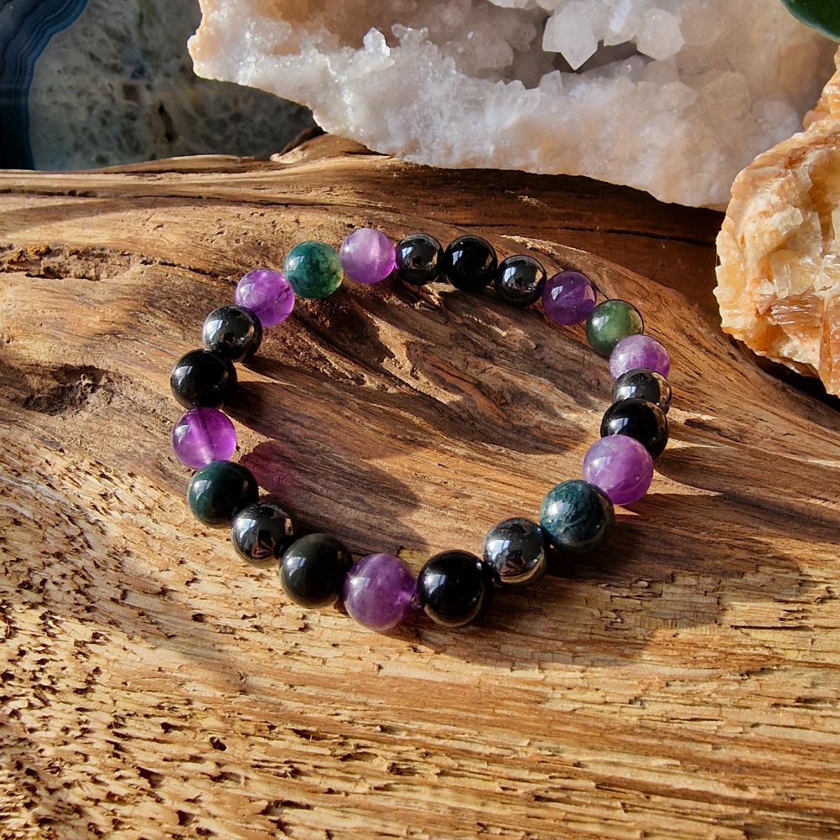 Pure Crystal's stress relief healing crystal bracelet is designed to ground you, calm your mind, and combat feelings of fear and insecurity. Made with natural beads of MOss Agate, Amethyst, Hematite and Obsidian. 