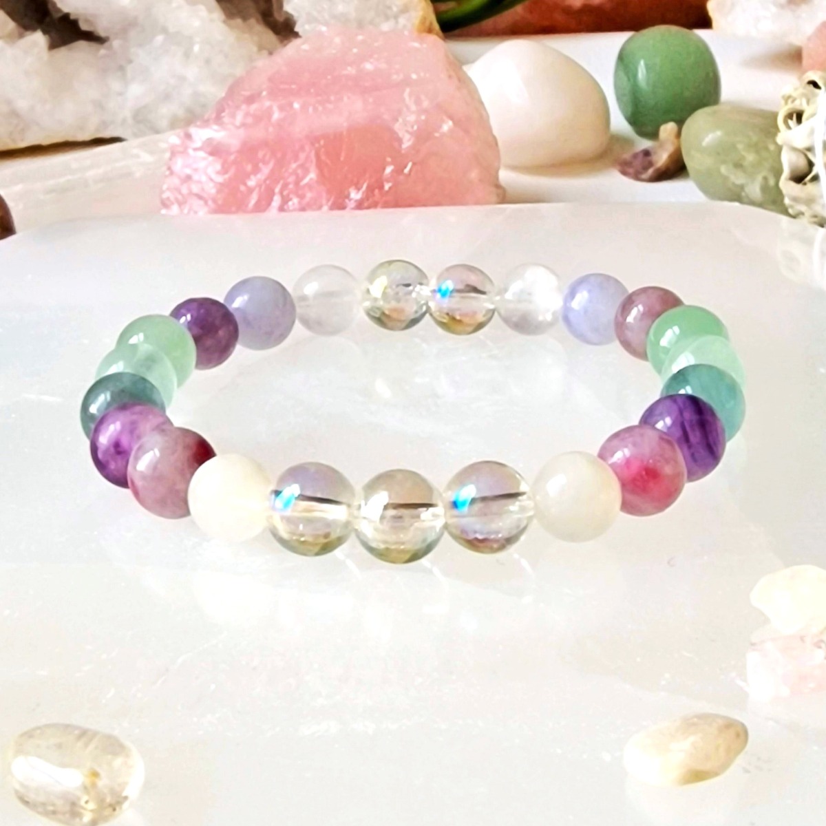 Fluorite, Moonstone, Aventurine, Aura Quartz, and Pink Tourmaline bracelet made with natural 8mm crystal beads and stretch cord.