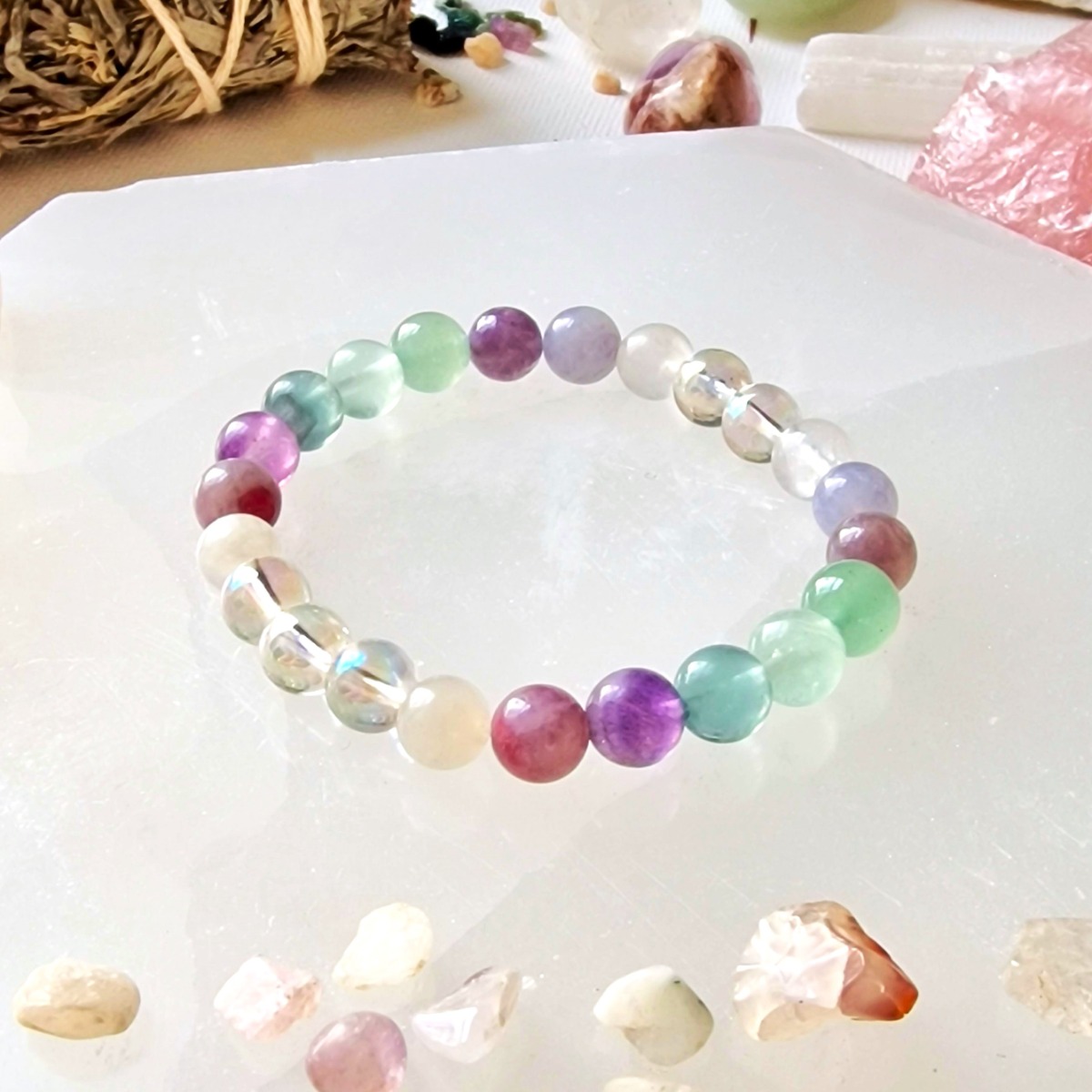 Pink Tourmaline, Moonstone, Fluorite, Aura Quartz, and Aventurine bracelet made with natural high-quality crystal beads and stretch cord.