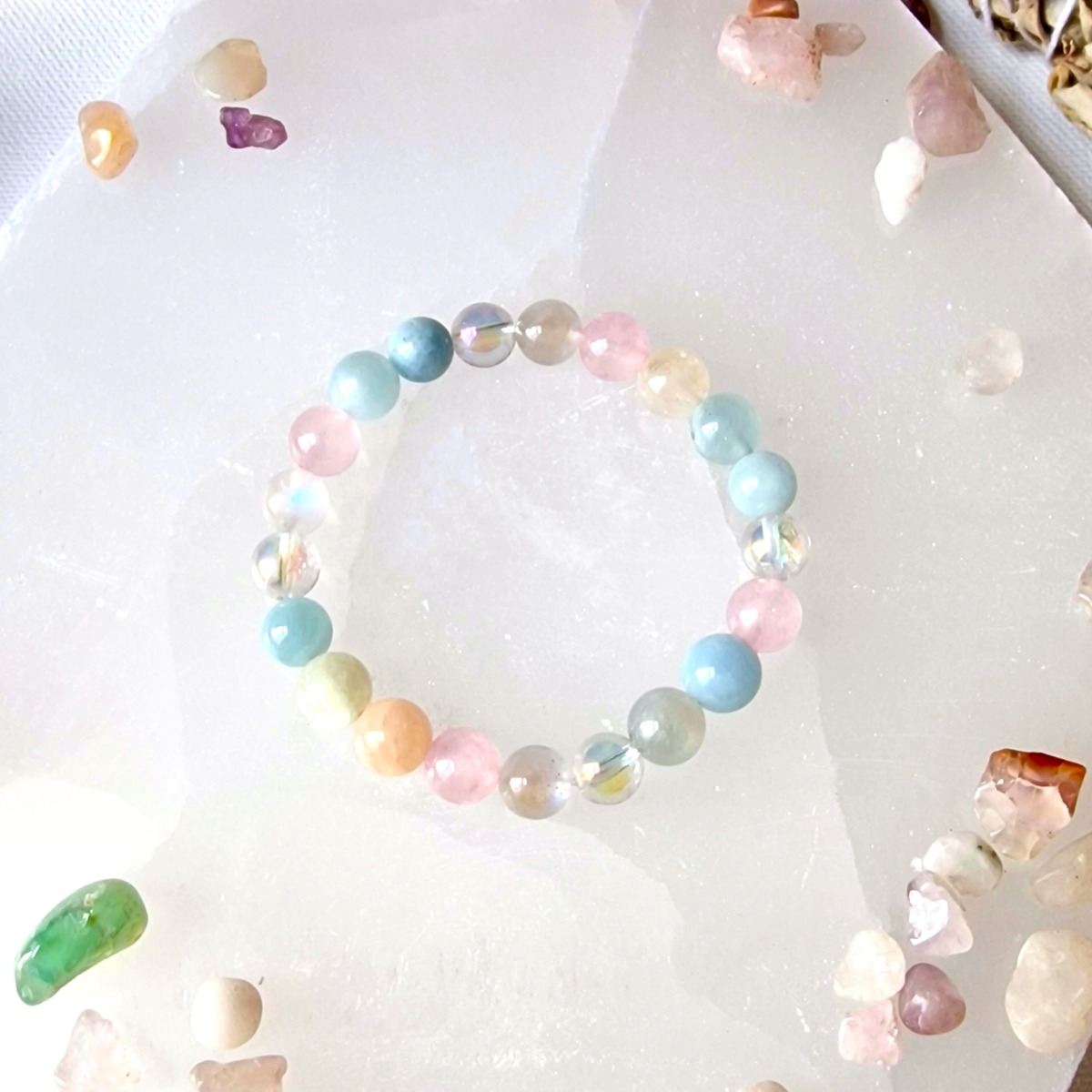 HIgh-vibrational crystal bracelet designed to manifest abundance and made with aura quartz, aquamarine, rose quartz and Morganite 